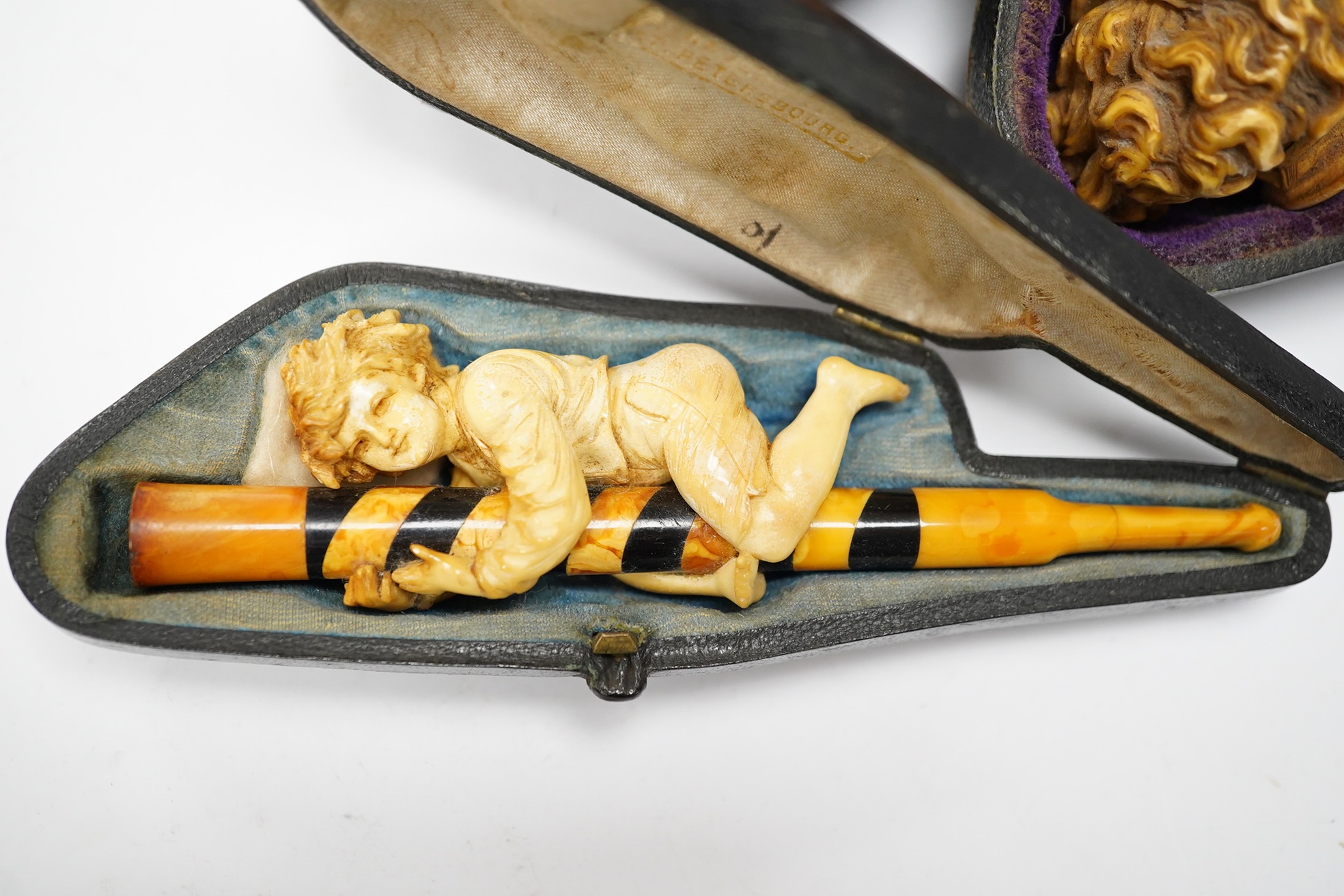 Three cased assorted Meerschaum pipes; sailor, boy on a pole and a Turk, largest Turk 19cm long. Condition - all pipes have damage either in pipe bowls or amber, cases worn